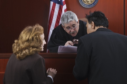 a judge talking to a couple of people
