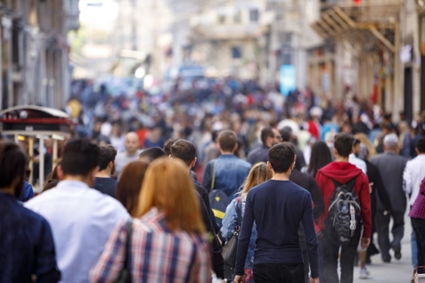 a crowd of people walking on a street
