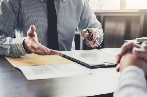 a man holding a pen over a clipboard