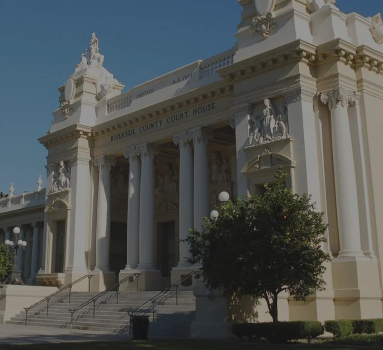 a white building with columns and statues
