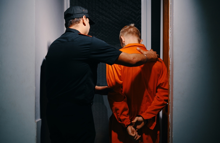 police officer walking suspect to interrogation room